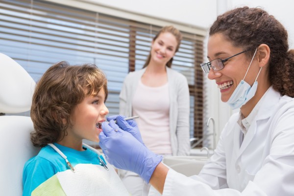 Dentist Giving Dental Treatment To Child